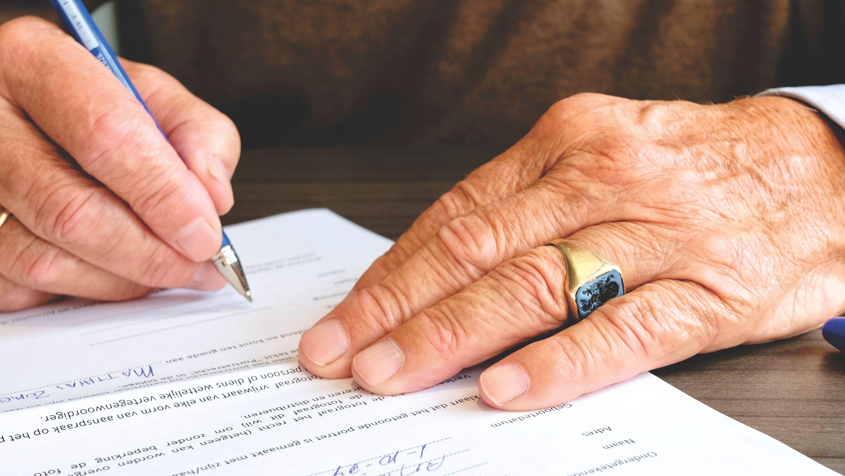 Signing a Wasiyat document to secure your family's legacy